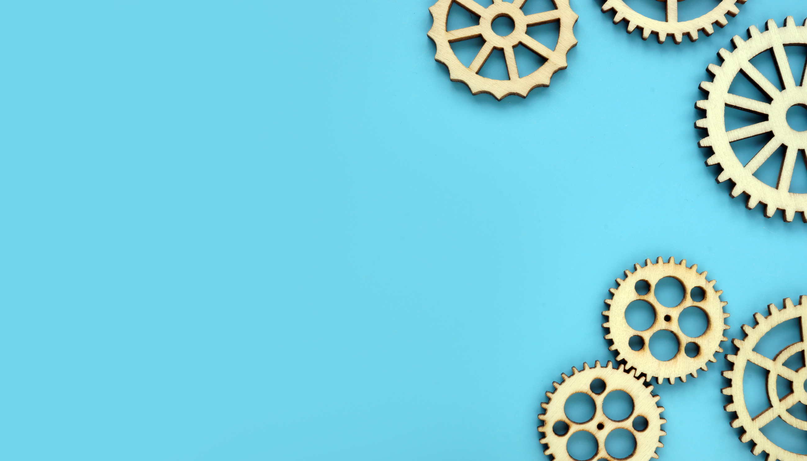 Blue background with wooden gears. Mind works and new ideas concept. Free space.